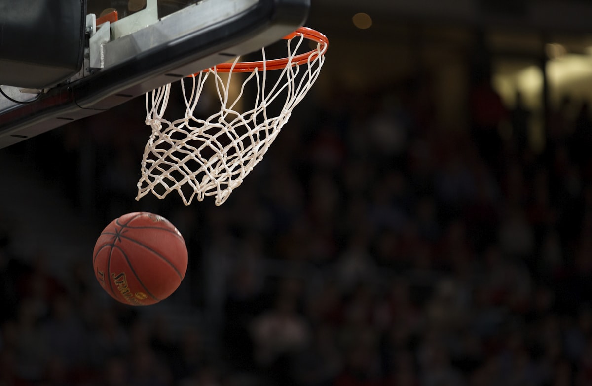 Basketball dropping through the hoop over a crowd